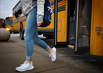  Girl stepping off school bus.